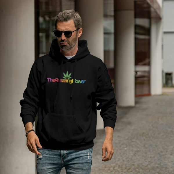 Hemp Leaf Rainbow Logo Hoodie (black) worn by a 40 something man with sunglasses and jeans with a short partially gray beard walking next to an office building